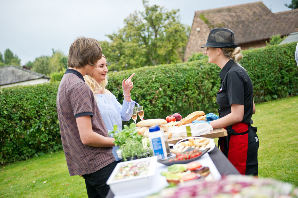 Clients discussing catering service options outdoors