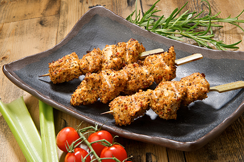 Crispy chicken skewers presented on dish